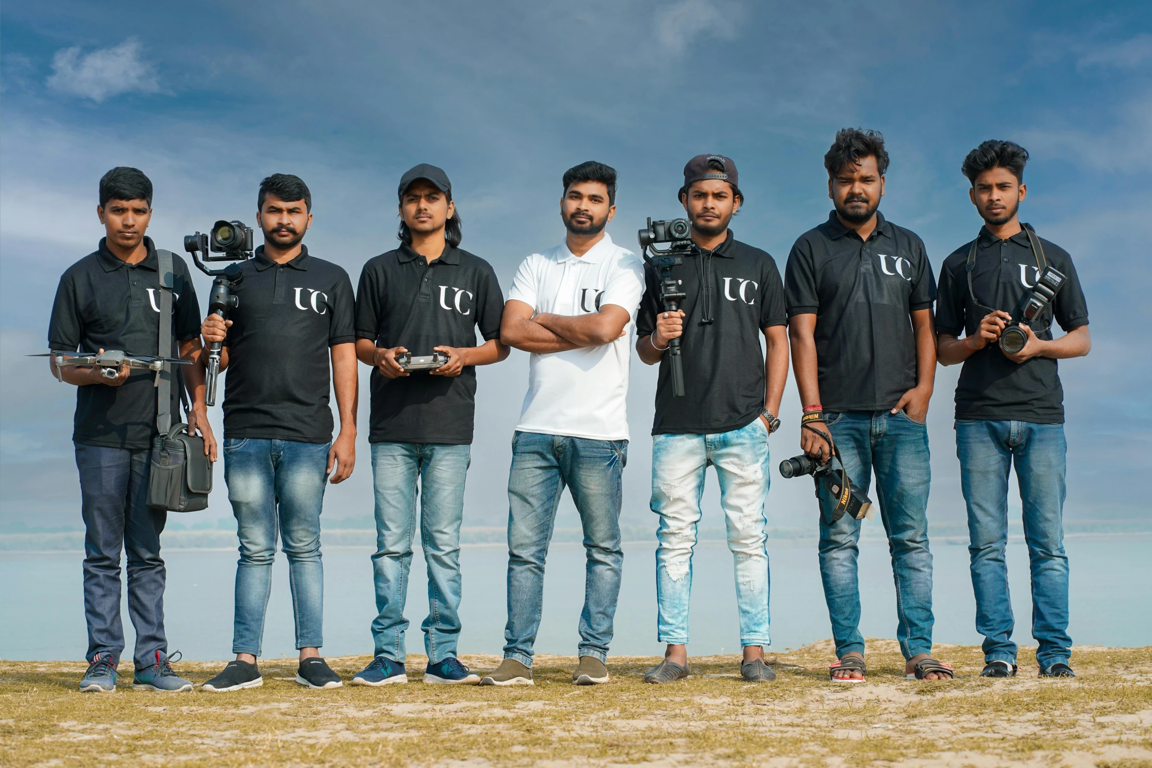 group po with cameraman and a pographer in black shirt