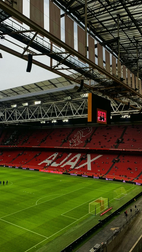 an empty stadium during the game, with red seats