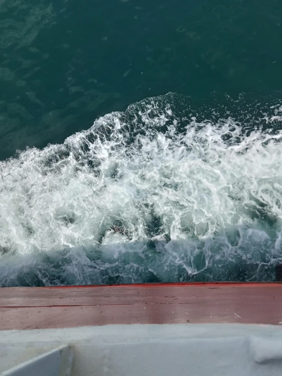 a person riding a surfboard while standing on a deck