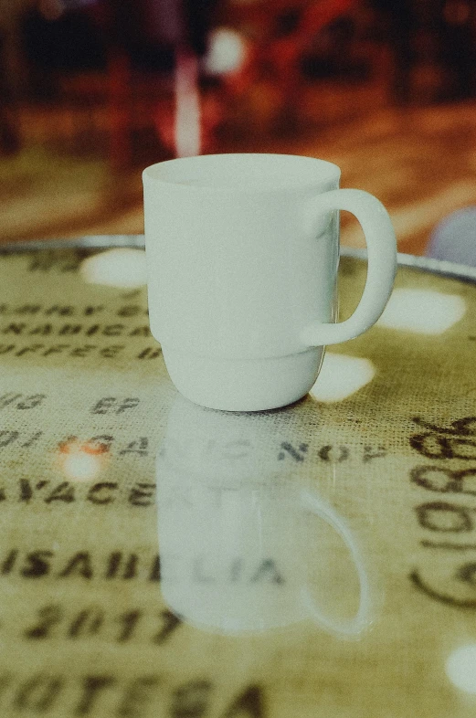 a white cup sitting on top of a table
