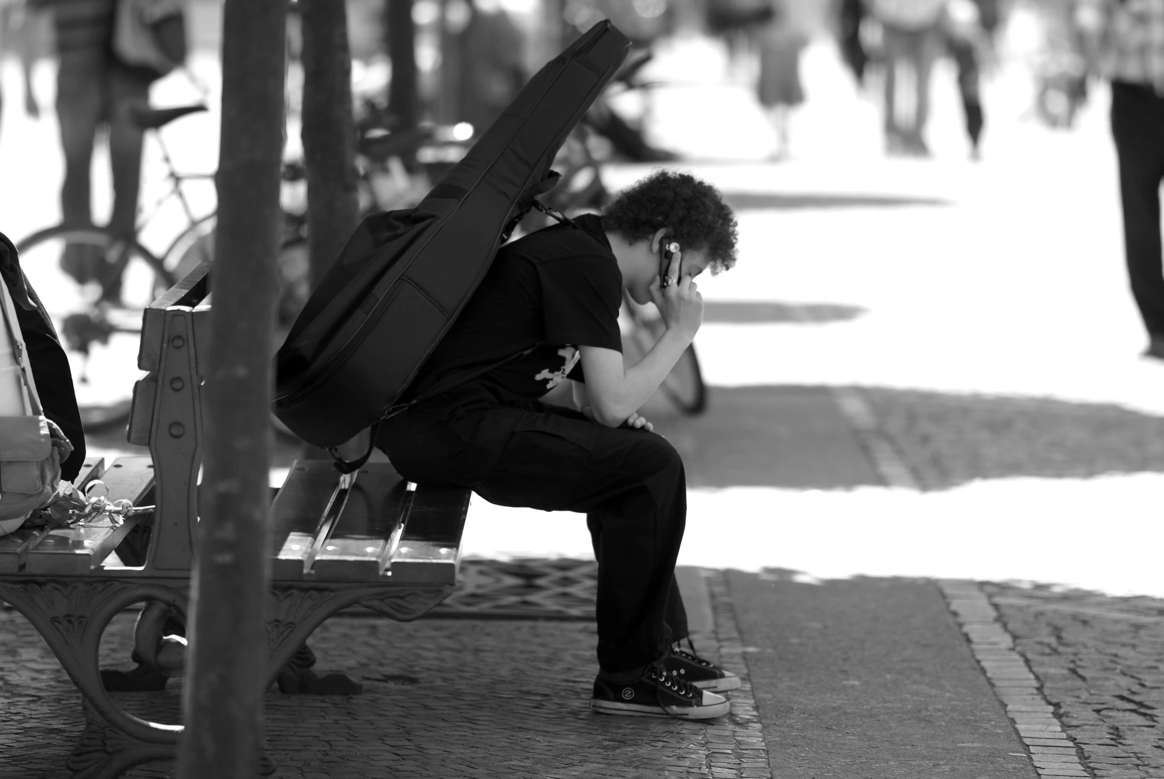 a person with a backpack on sitting at a bench