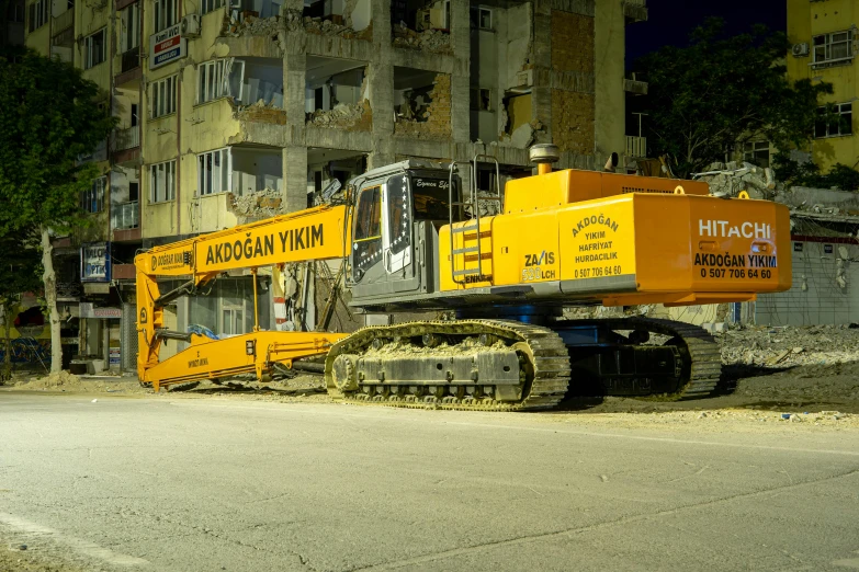 a large yellow construction machinery parked on a road