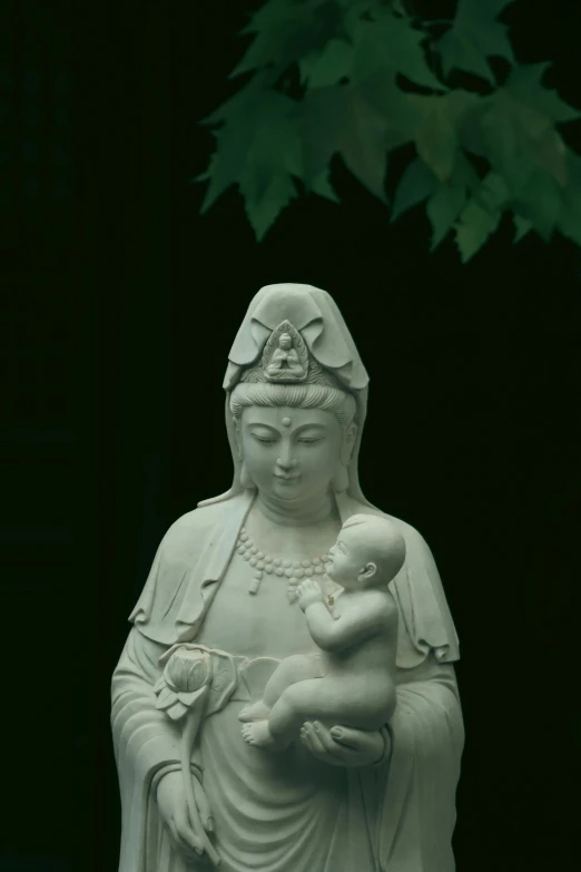 a statue of a woman holding a baby