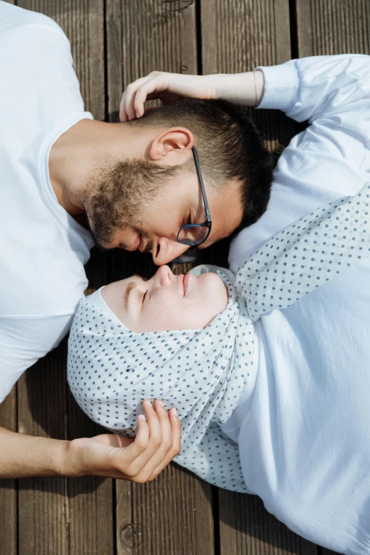 a man and a woman laying on top of each other