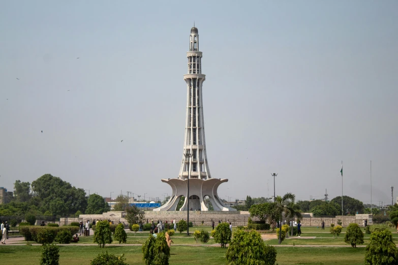 a tall tower sitting in the middle of a park