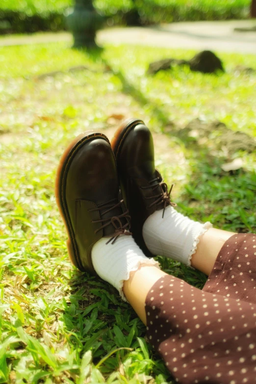 a pair of boots sitting on top of a green field