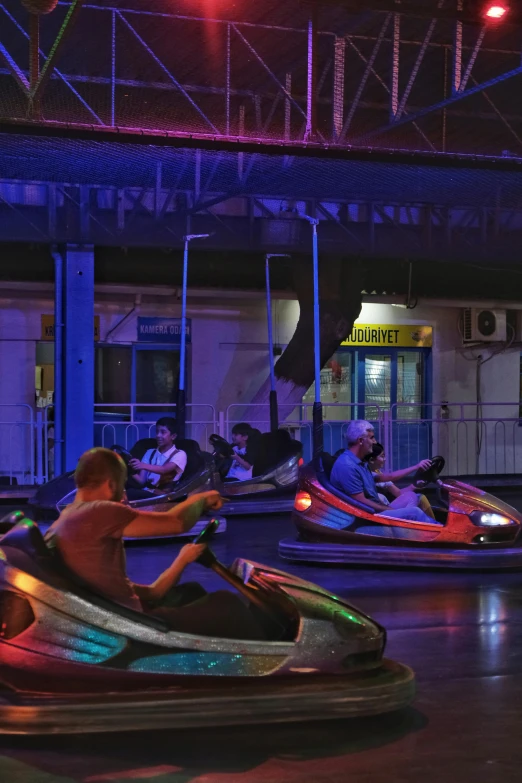 several s in bumper cars in a brightly lit room