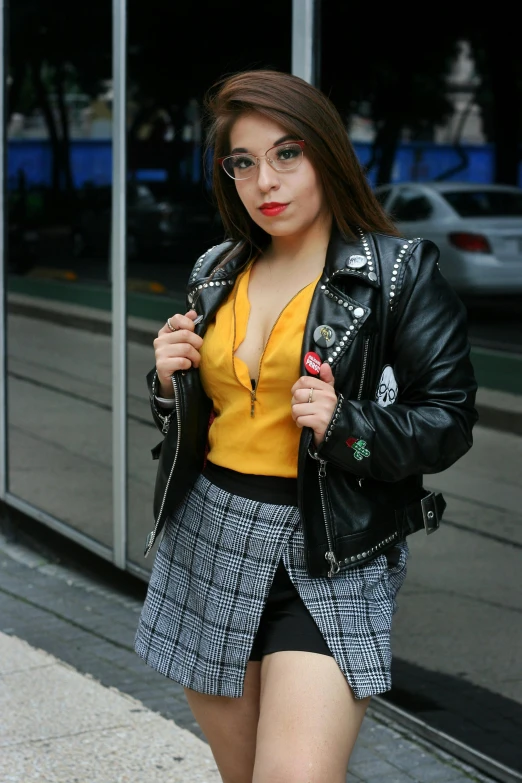 woman in black and white plaid skirt wearing glasses