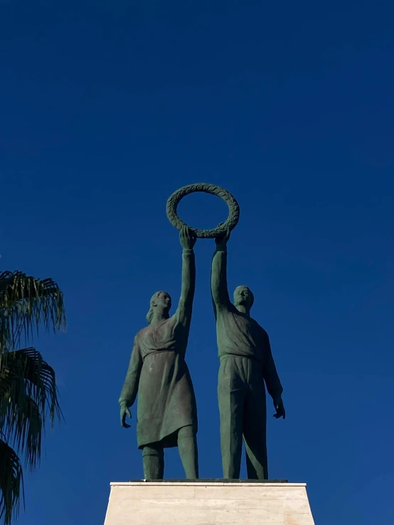 two statues are being lifted by another person