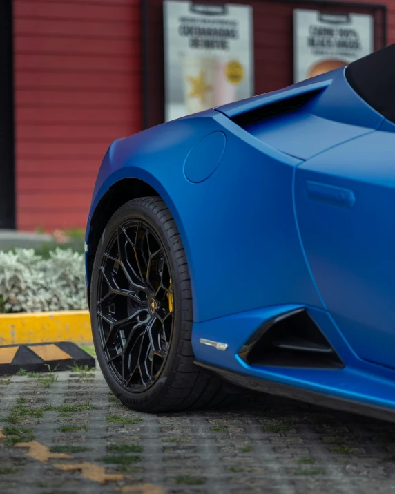 close up s of a blue sports car parked