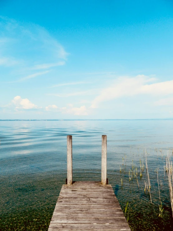 a dock extends to the edge of a shallow body of water