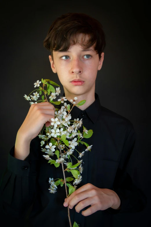 a  holding flowers and staring into the camera