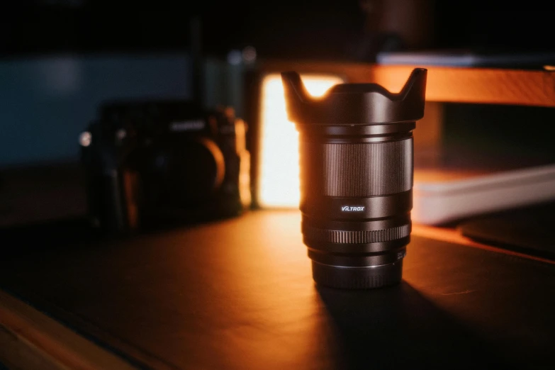 a camera lens cup sitting next to a stove