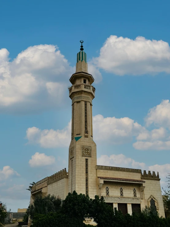 a very tall clock tower in a city with sky in background