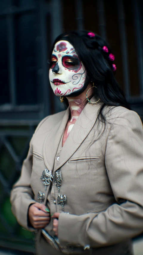 the woman in makeup has skull eyes and pink beads