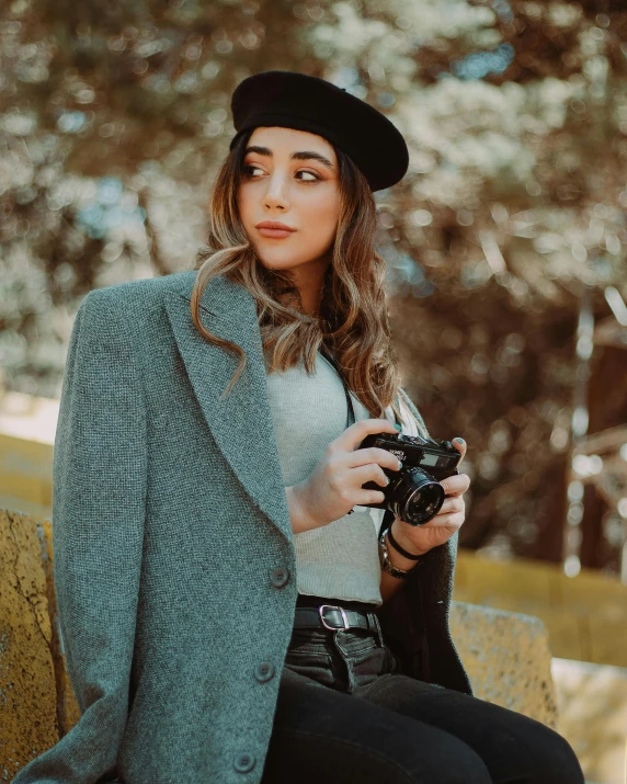 the woman is taking a selfie while holding her camera