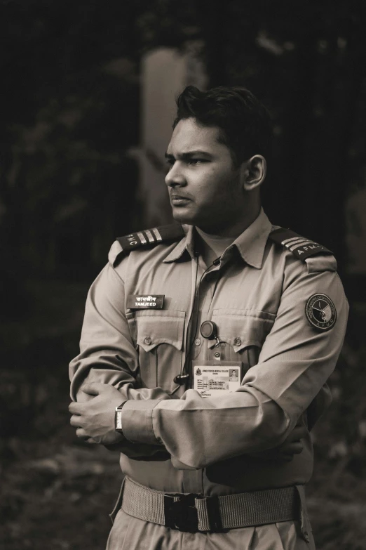 a man in uniform with his hands crossed