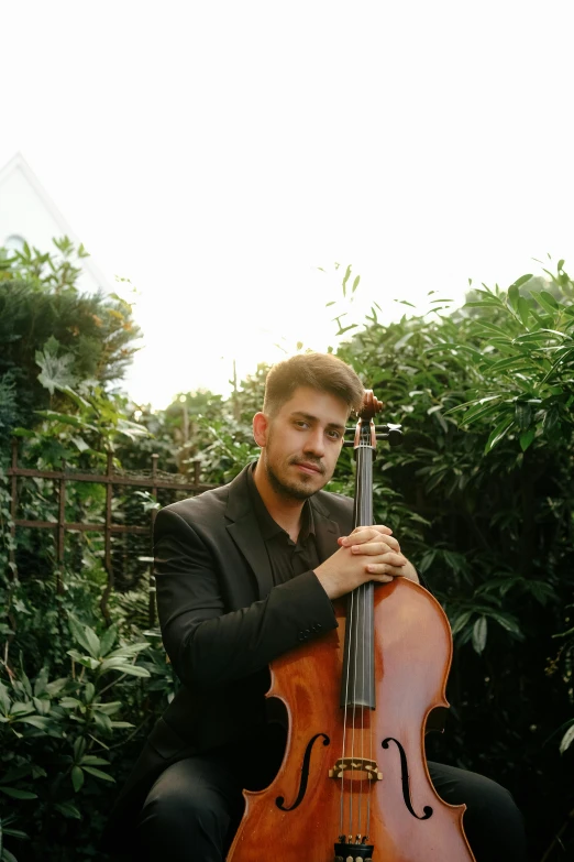 a man with a violin in his hands posing for a picture