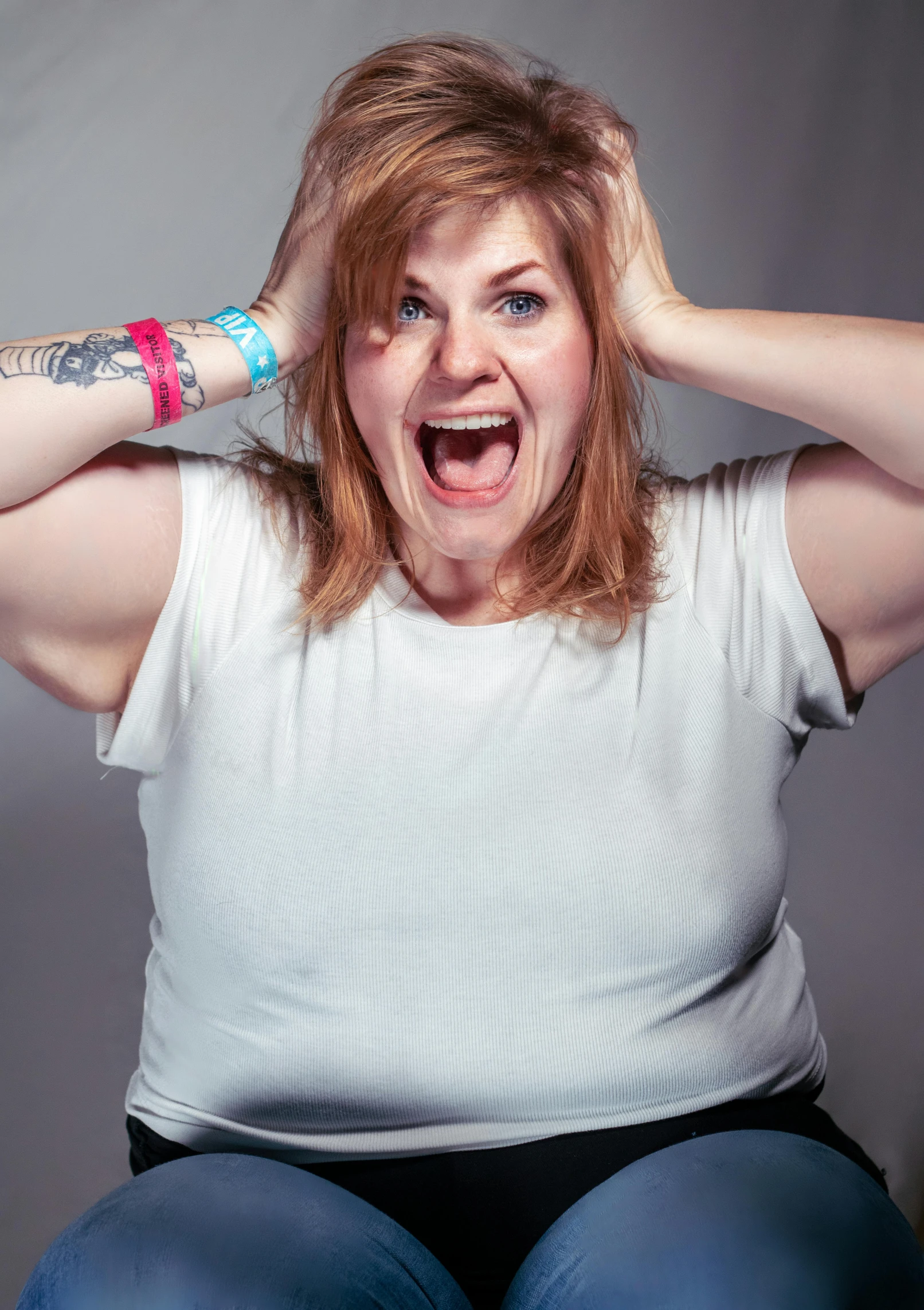 a woman with a tattoo is putting her hair in place of lifting it