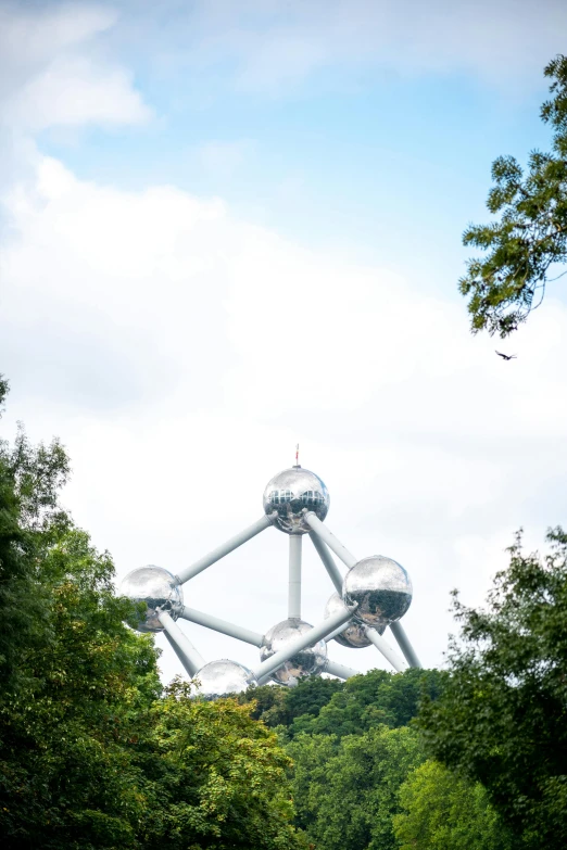 a very large structure is in the middle of some trees