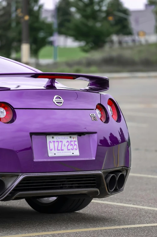 a purple nissan coupe car in a parking lot