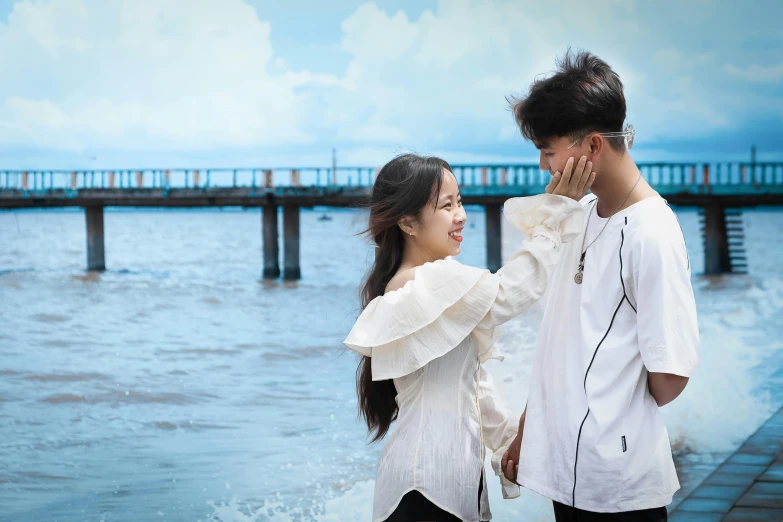 the young man is standing next to the woman