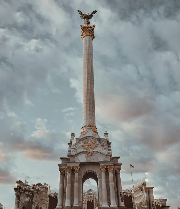 a monument with a statue at the base of it