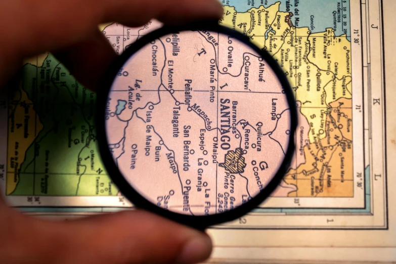 a magnifying glass being held up to a map