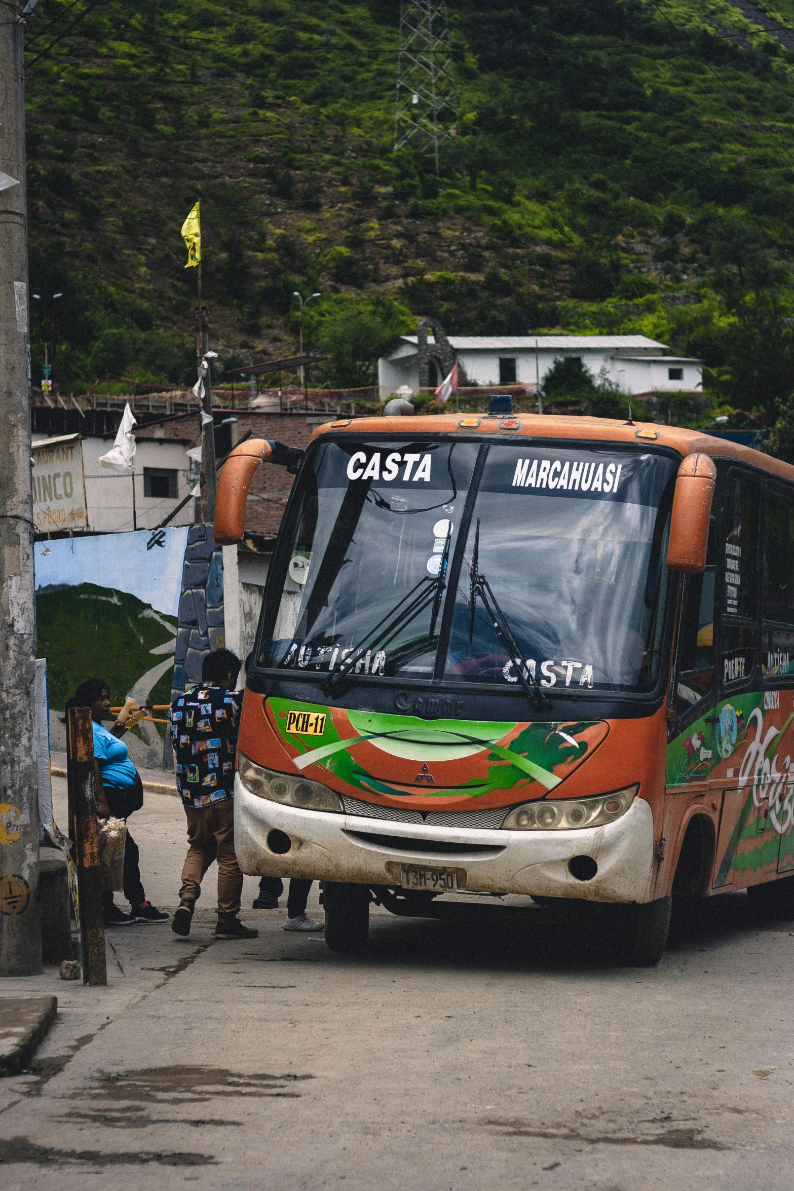 several men are standing around the old bus