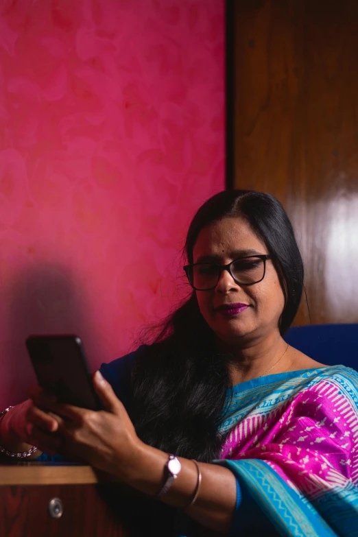 a woman in a sari uses her cell phone