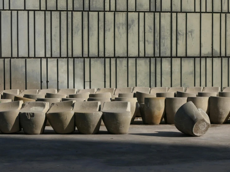 a row of vases in a large concrete building