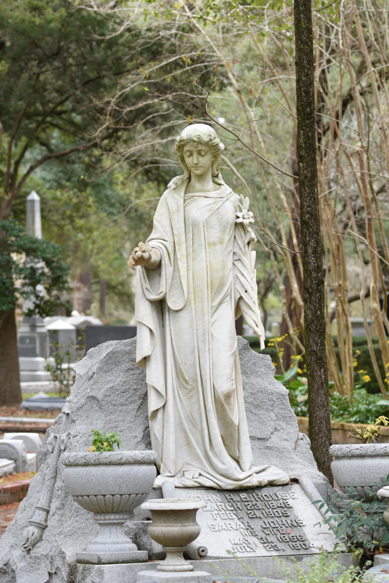 the statue has been decorated with flowers and plants