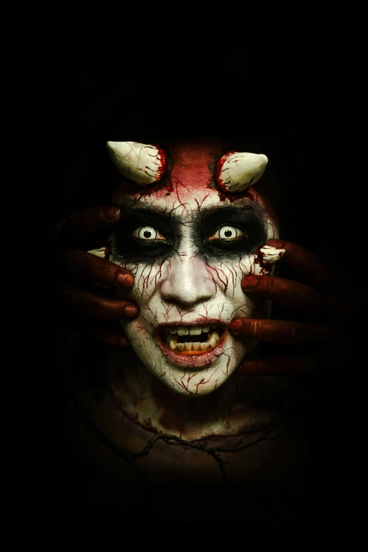 a male clown making a creepy face with his hands
