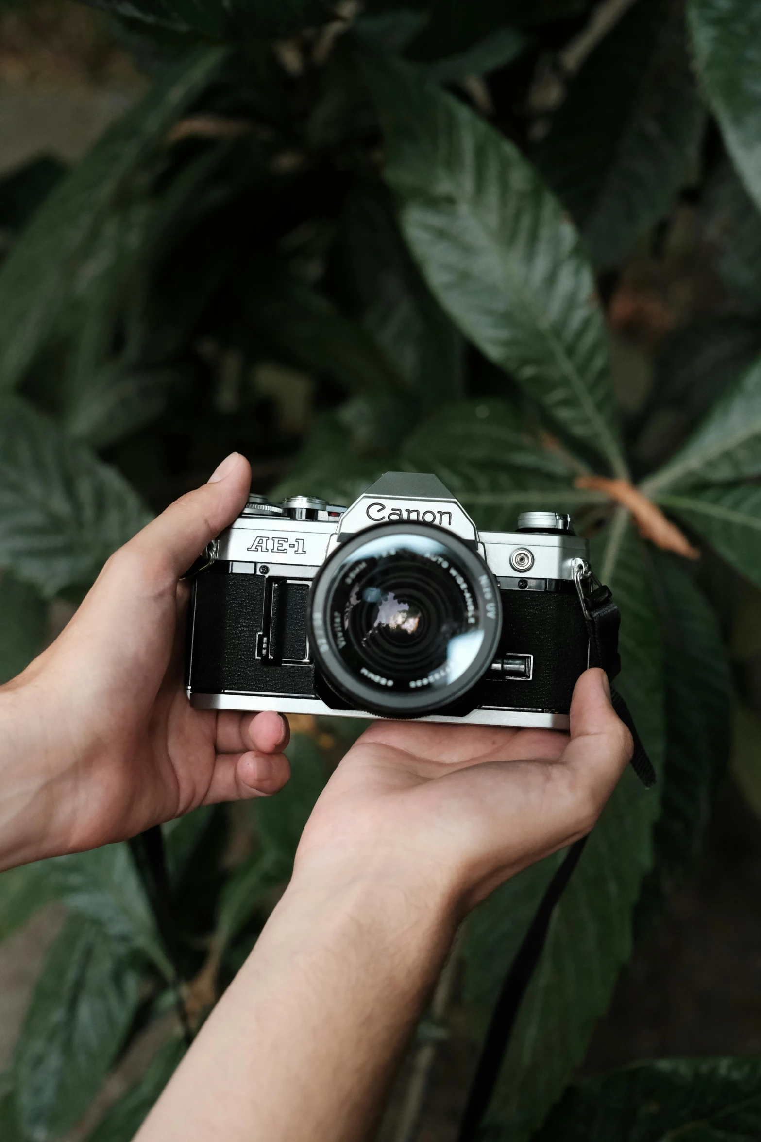 a man holding up a digital camera to take a picture