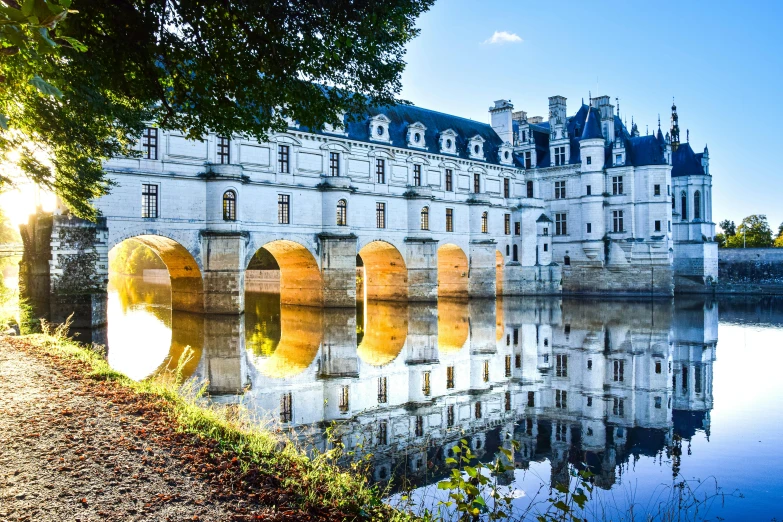 a castle sitting on top of a bridge over water