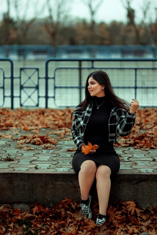 a woman is sitting down on some stairs