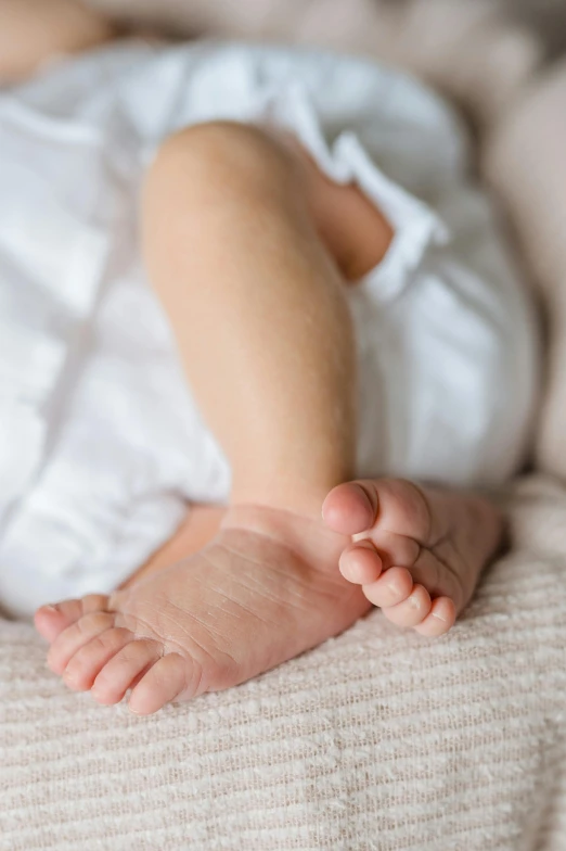 an infant laying on its back with their feet in the air