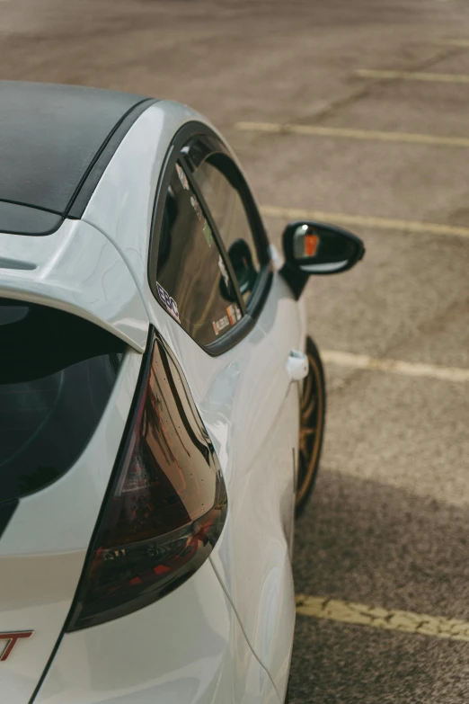 a car parked in a parking lot with it's rear end open