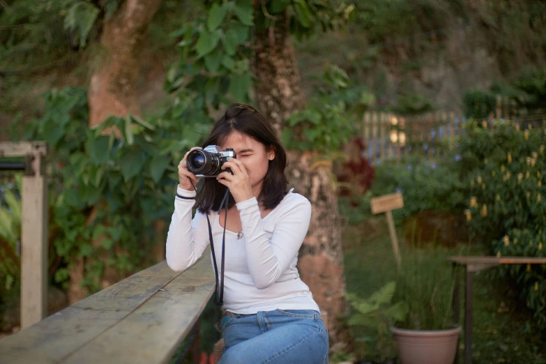 a woman kneeling down and taking pictures with her camera