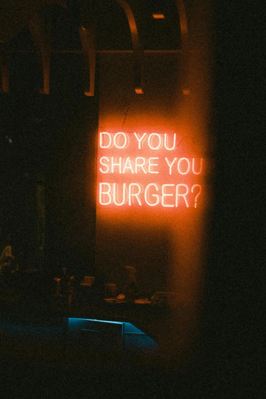 a lit sign that reads do you share you burger?