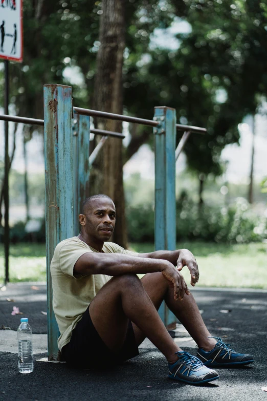 a man sitting on the ground with his arm folded