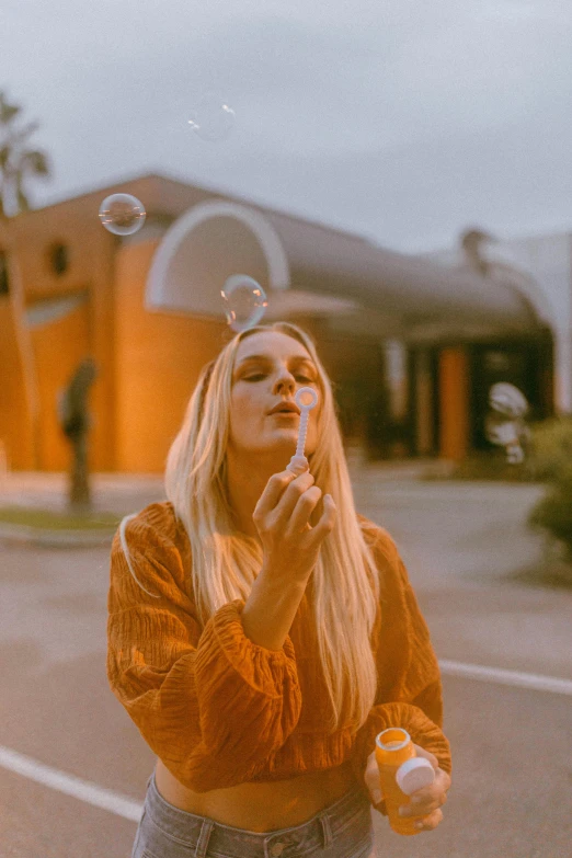 a woman blowing bubbles outside of a building