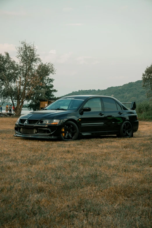 a black car parked on the side of a road