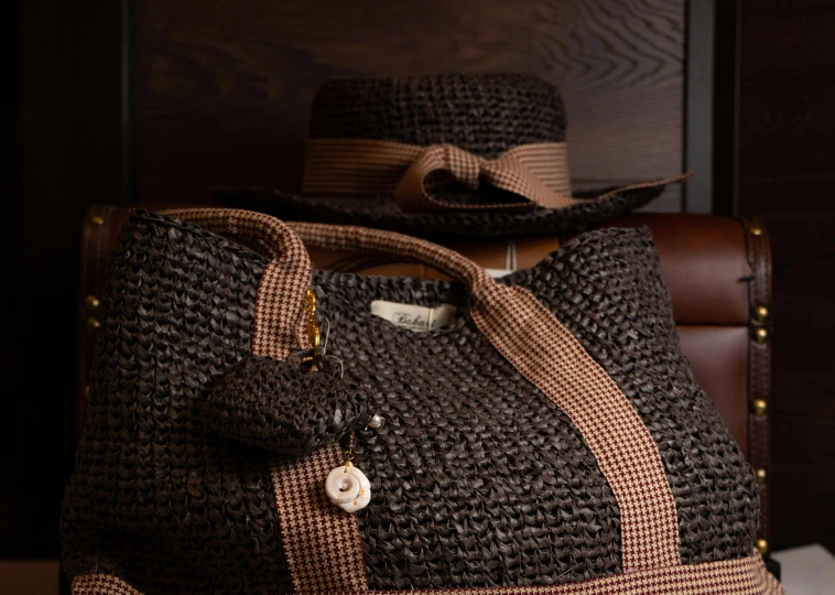 two straw hats on top of a bag