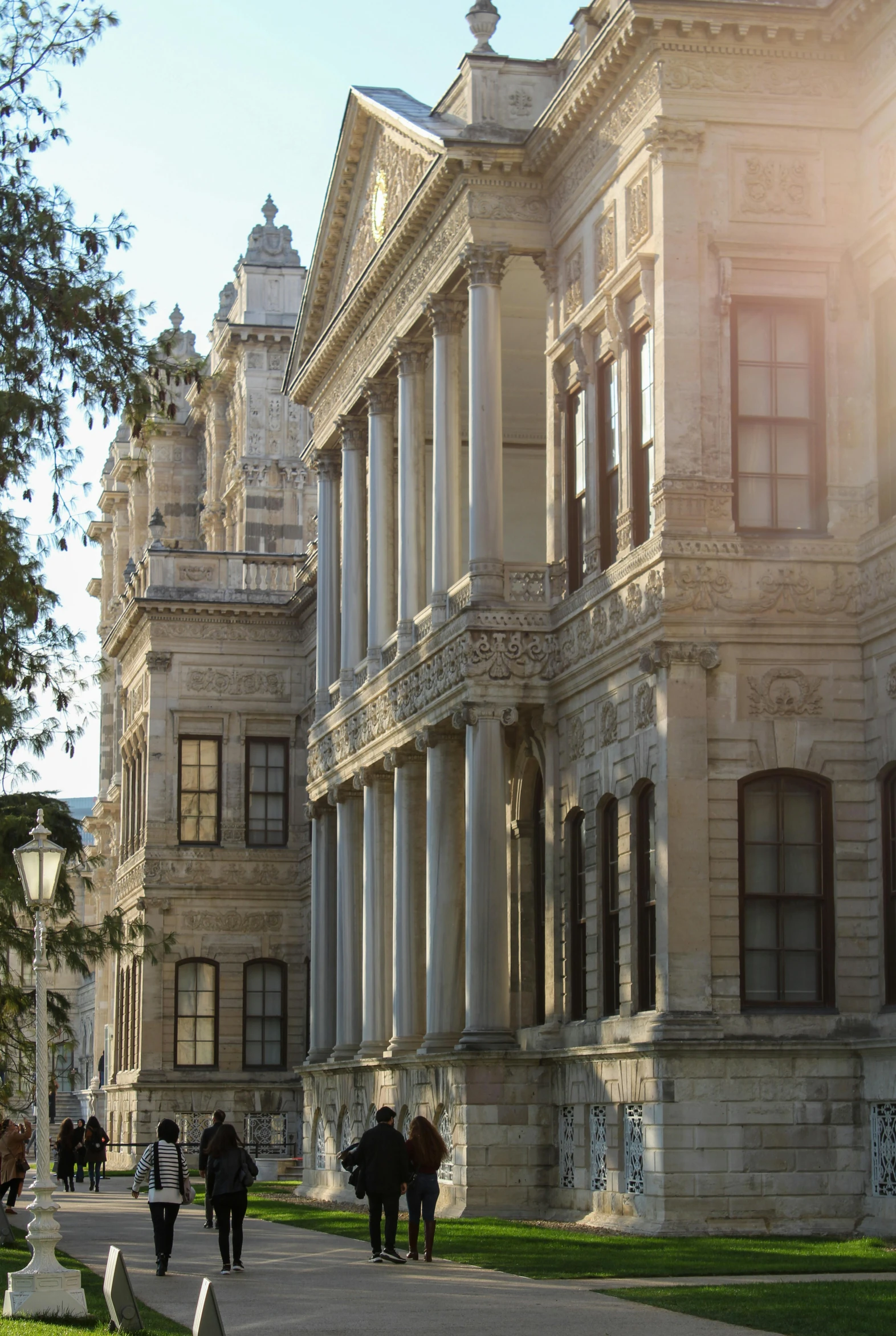 a couple of people that are walking past some buildings