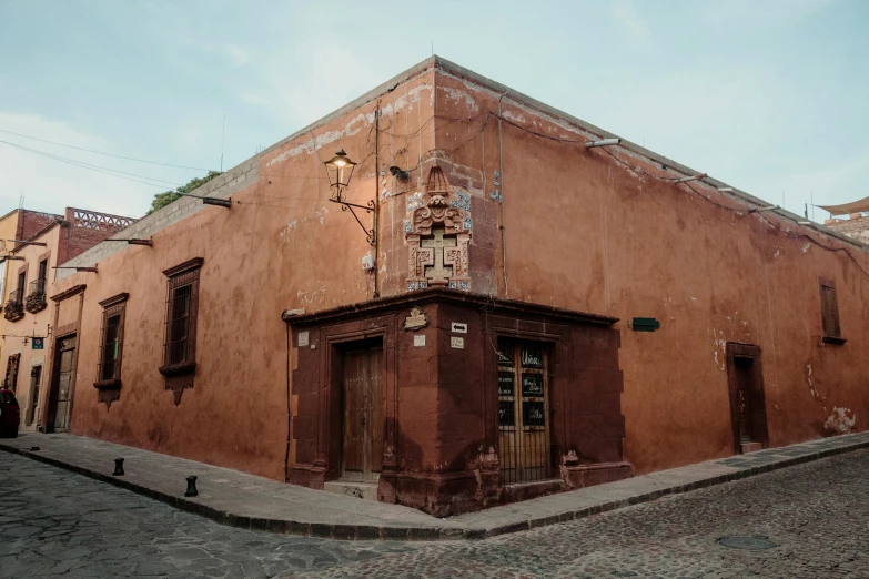 old red building with an intricate wood carving on the top