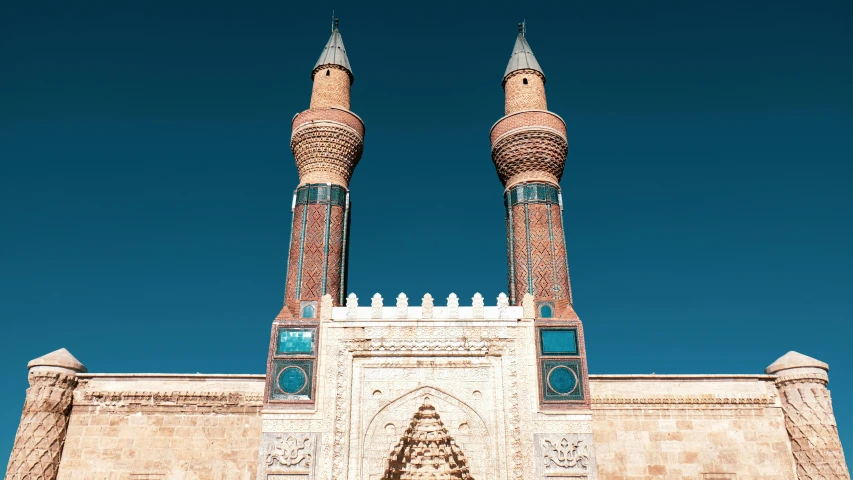 two large towers standing up against the blue sky