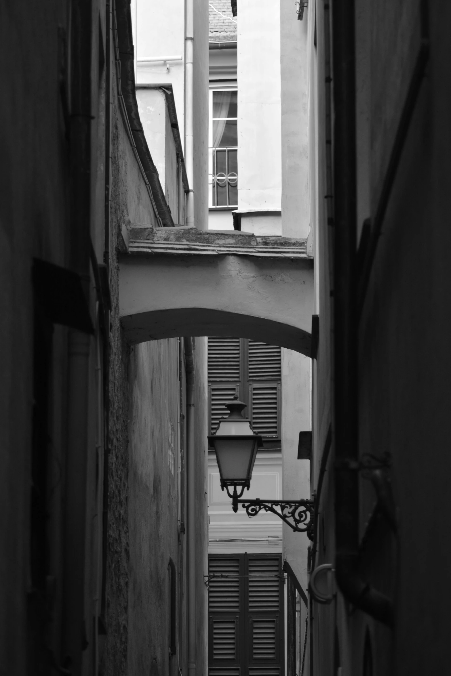 an empty alley with a building seen through a door