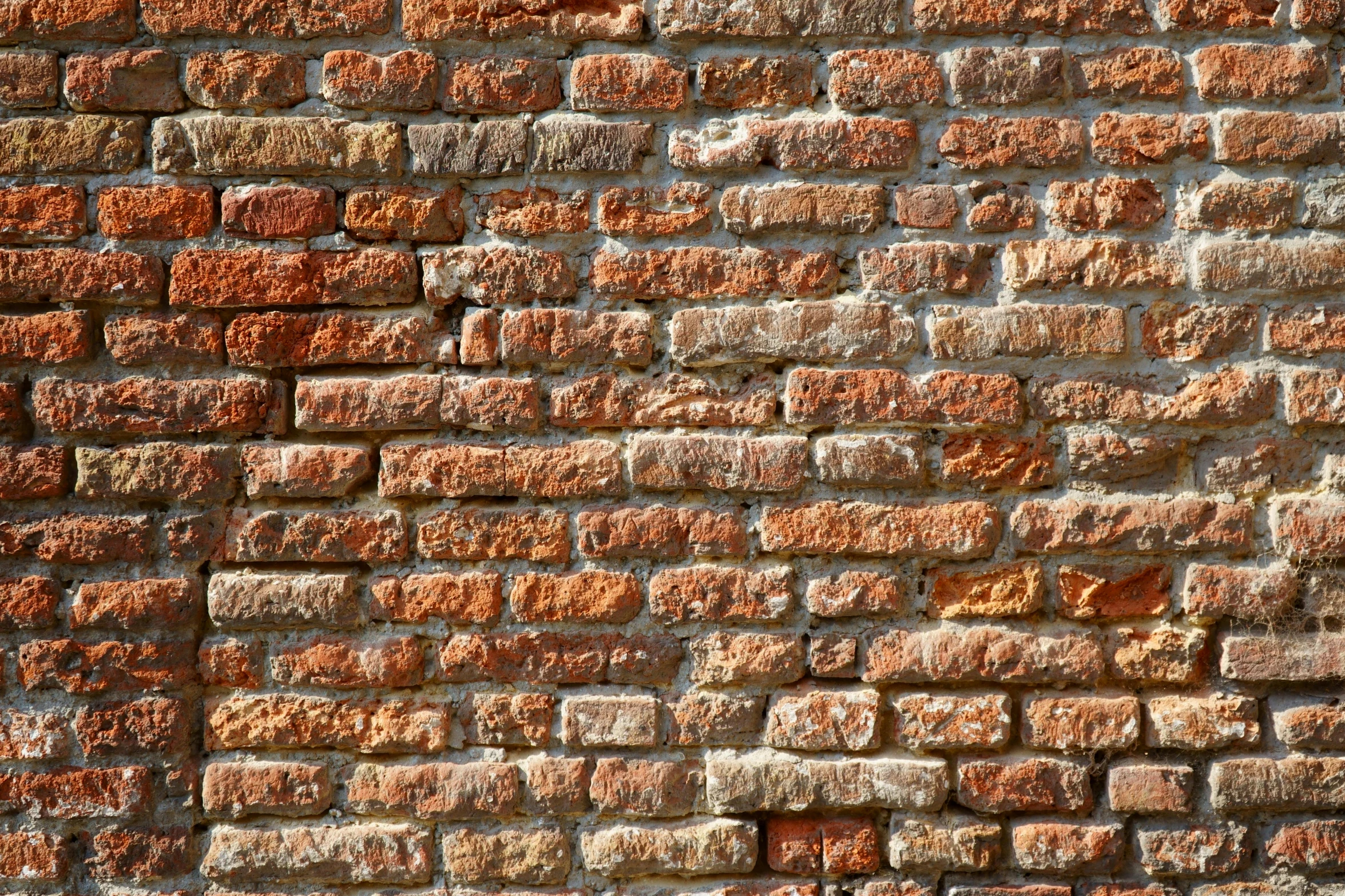 an old brick wall, with some brown and tan paint