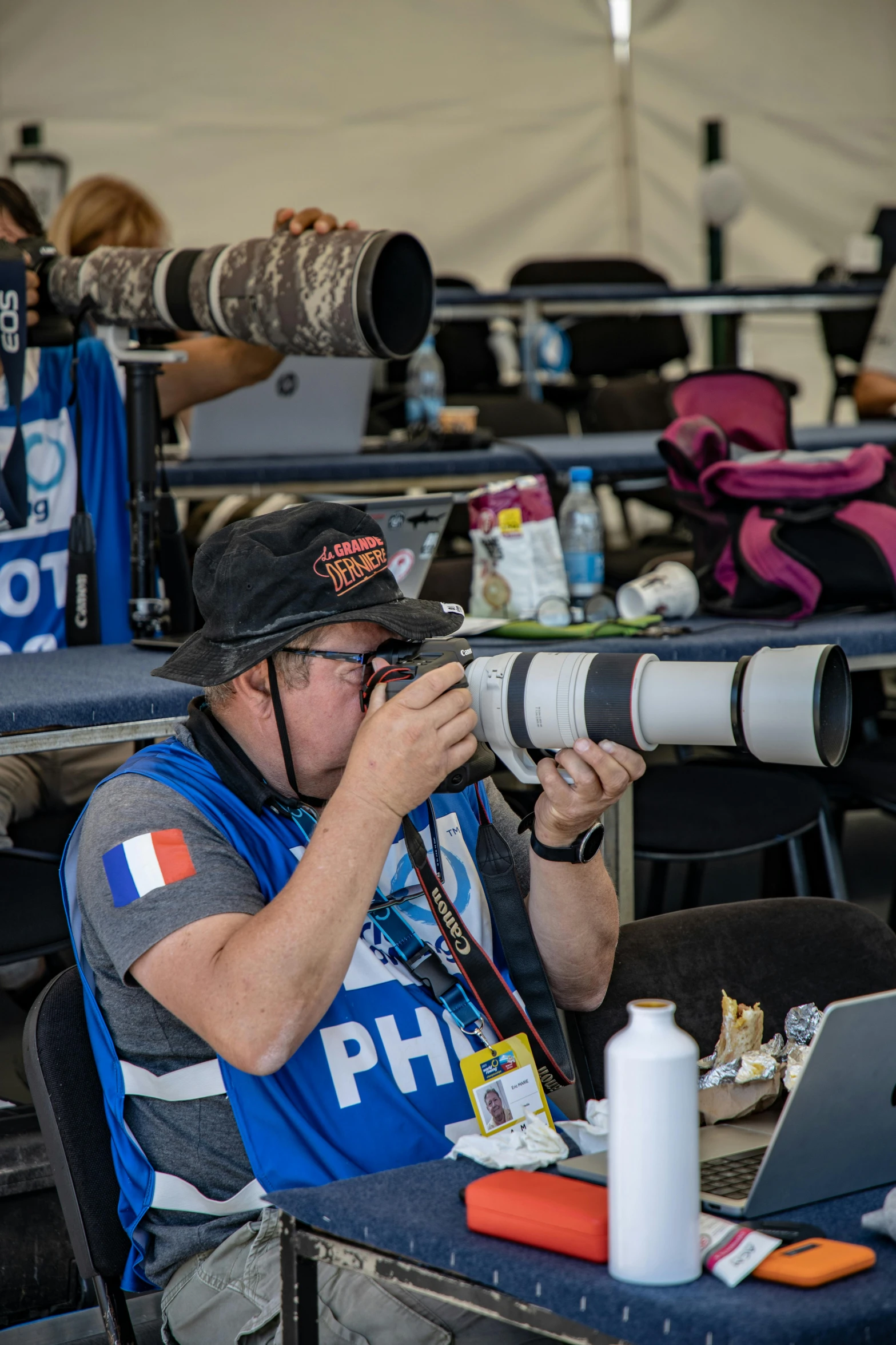 a man sitting down with a camera in front of him